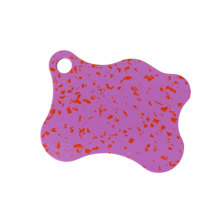 Nibble & Rest Raspberry Mama chopping board in pink with red flecks featuring an organic wave shape and a hanging hole.