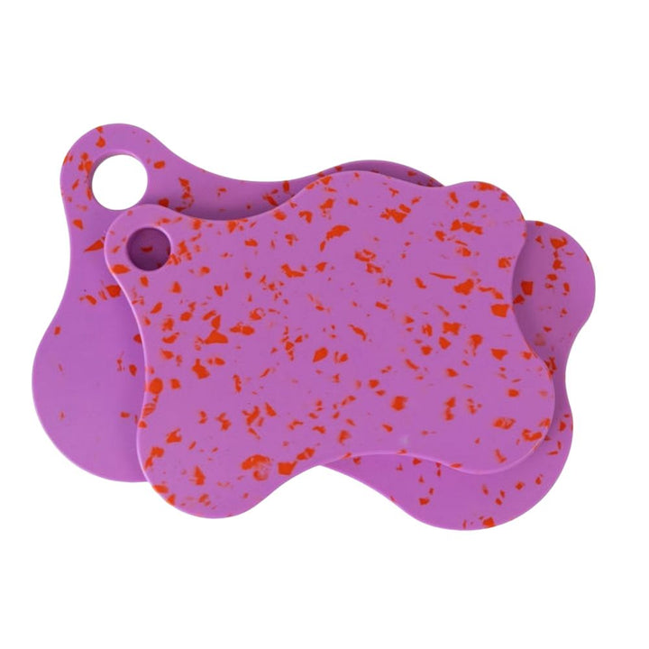 Nibble & Rest Raspberry Mama and Mini chopping board set stacked together, featuring a purple and red orange speckled design with hanging holes.